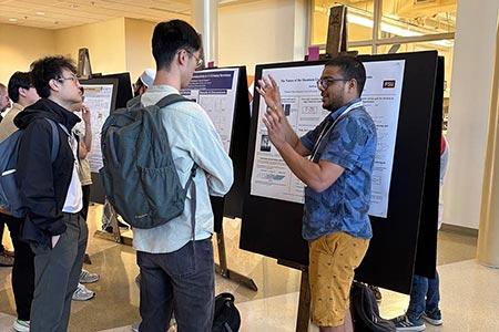 Students talking in front of display board